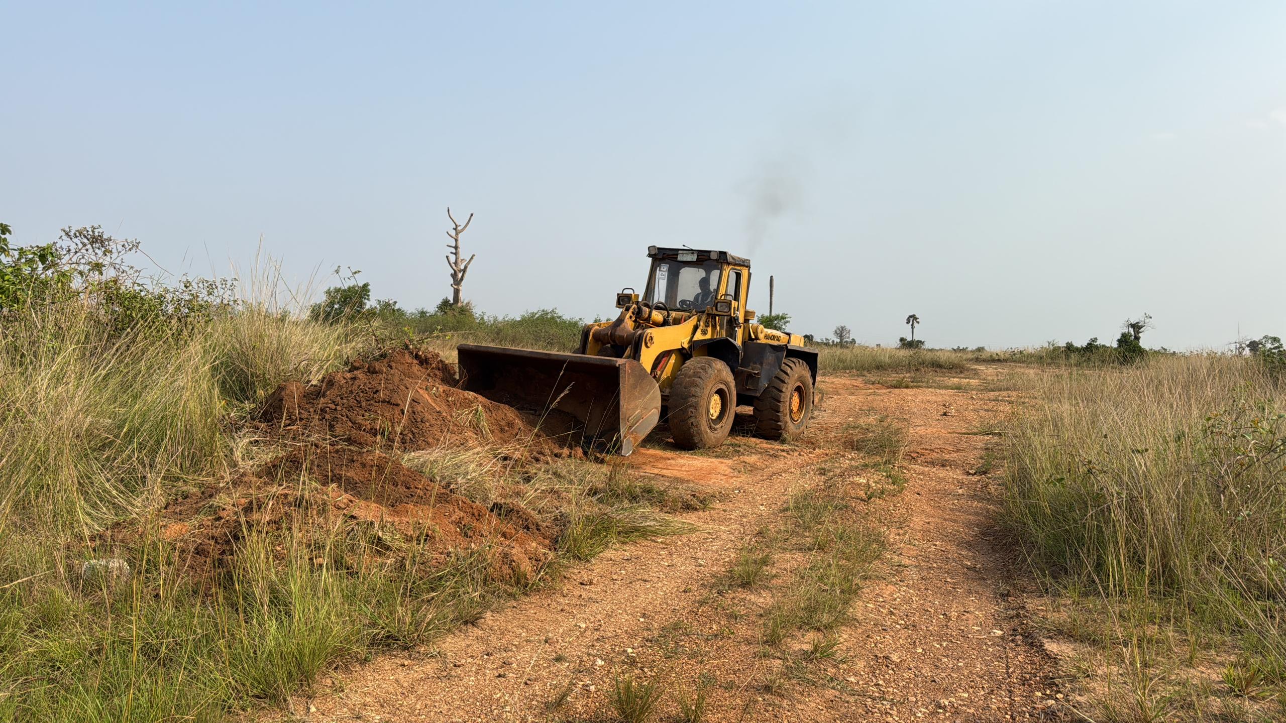 Heavy machinery doing land clearing for construction project in Ghana